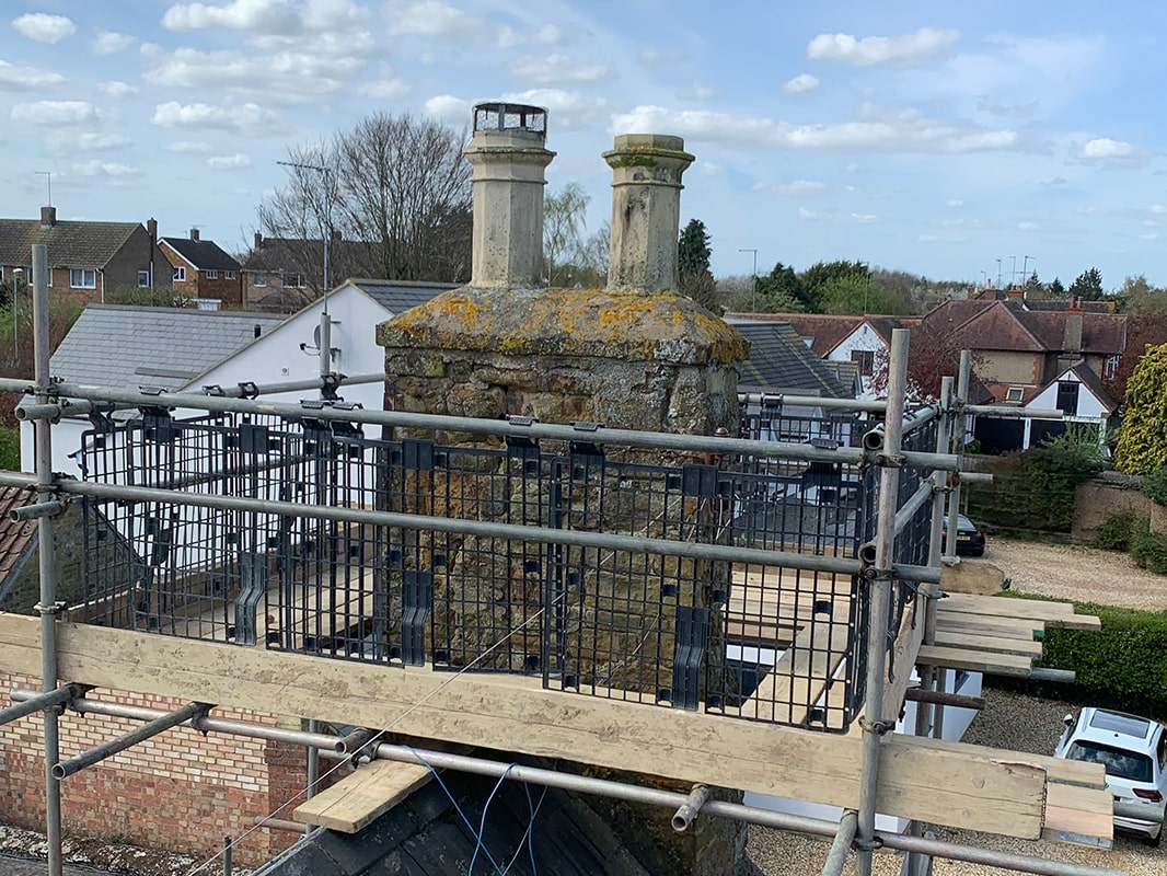 Damaged chimney surrounded by scaffolding