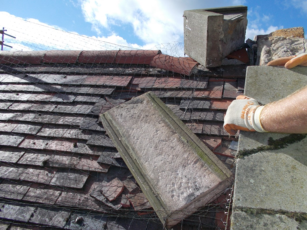 Damaged chimney and surrounding tiles